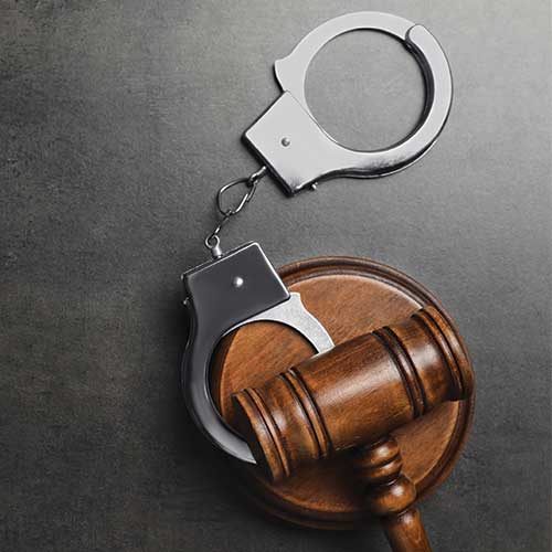 Handcuffs and a wooden judge's gavel